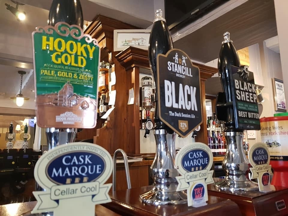 Cask ales on the bar at The Eagle and Child